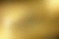 Light shining on rough gold metal panel, abstract texture background Royalty Free Stock Photo