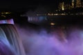 Light showcase lighting cascades of water Niagara Falls. Illuminated night view of Niagara Falls. USA. Royalty Free Stock Photo