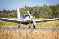 Light single engine aircraft in white accelerates for takeoff Royalty Free Stock Photo