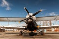 Light single-engine airplane front view: propeller with four blades, wing and wheels Royalty Free Stock Photo