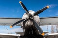 Light single-engine airplane front view: propeller with four blades, wing and wheels Royalty Free Stock Photo