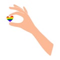A light-skinned hand holds a rainbow heart. LGBT.Dark skin.A heart between your fingers.Flat illustration.Love and happiness. Royalty Free Stock Photo
