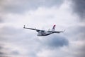 Light small plane flies against the background of white rainy clouds not high above the ground. Light aircraft on the air. A small Royalty Free Stock Photo