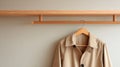 Light Spring Jacket Hanging on Wooden Hanger in Minimal Interior With Empty Pastel Wall Space Providing a Simple Royalty Free Stock Photo