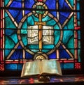 Light from stained glass window falls on open bible in american church Royalty Free Stock Photo