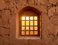 Light through stone window with metal bars in an ancient wall Royalty Free Stock Photo