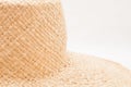 Light straw wicker hat as abstract fashion background on white color