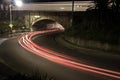 Light streaks under and over an old bridge. Royalty Free Stock Photo