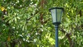 Light street lamp on green nature in the park background. Royalty Free Stock Photo