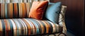 A light, striped couch with colorful pillows on hardwood flooring in a room Royalty Free Stock Photo