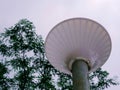 Light structure in white color with standing metal pole at sky background