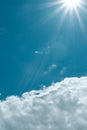 Light from sunbeams over white cloud against cyan blue sky. Vibrant seasonal background