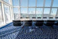 Light, sunny boardroom with bent tubular steel chairs and blue carpet with geometric pattern, at the Aga Khan Centre, London