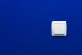 Light switch on blue wall background. Interior design. Minimal style Royalty Free Stock Photo
