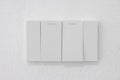 Light switch, Close-up White plastic mechanical switch mounted on a white wall Royalty Free Stock Photo