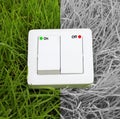 Light switch on a green grass background Royalty Free Stock Photo