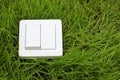 Light switch on a green grass background Royalty Free Stock Photo