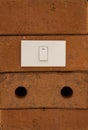 Light switch on red brick wall Royalty Free Stock Photo