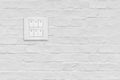 Light switch on white brick wall. Royalty Free Stock Photo