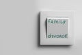 Light switch with words Family and Divorce on white wall, space for text Royalty Free Stock Photo