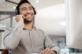 Light tomorrow with today. a young businessman wearing a headset while working in an office. Royalty Free Stock Photo