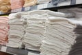 Light towels in stacks on the shelf in the store