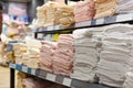 Light towels in stacks on the shelf in the store