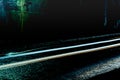 Light trails from cars passing through a dark tunnel on a rainy night Royalty Free Stock Photo