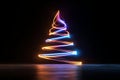 Light trails forming christmas tree shape against dark background, creating festive atmosphere Royalty Free Stock Photo