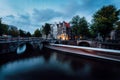 Light trails at the Leidsegracht and Keizersgracht canals in Amsterdam at dusk. Long exposure shot