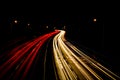 Light trails from moving car headlights and rear vehicle lights creating moving blurred motion at night Royalty Free Stock Photo