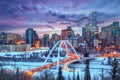 Light trails from rush hour traffic light up Walterdale Bridge in Edmonton, Canada, on a sunset winter night Royalty Free Stock Photo