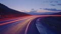Light trails streaking through the air as a car maneuvers around a sharp bend on a deserted windy road Royalty Free Stock Photo