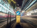 Bus and Tram Light Trails on a Hong Kong City Street with a Keep Left Sign Royalty Free Stock Photo