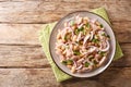 Light tuna salad with white beans and onions close-up in a plate. horizontal top view Royalty Free Stock Photo