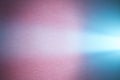 Light turquoise ray of light crosses a light blue smooth and dark pink textural background Royalty Free Stock Photo