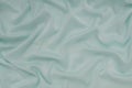 Light turquoise satin material, blue sateen fabric, silk textile Royalty Free Stock Photo