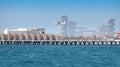 light twin engine propeller plane takes off from the runway from an artificial island in Dubai. Large construction sites in the Royalty Free Stock Photo