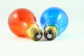 Light up Close up of a red and a blue lightbulb, photographic effects on a all white background Royalty Free Stock Photo