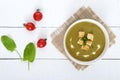 Light vegan spinach cream soup with crispy croutons in a bowl on a white background Royalty Free Stock Photo