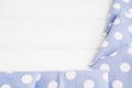 Light violet blue polka dots folded tablecloth over bleached wooden table. Top view image. Copyspace for your text. Royalty Free Stock Photo