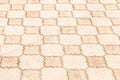 Light warm color paving slabs urban floor with geometric pattern texture city background Royalty Free Stock Photo