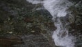 Light water close-up.Creative.A small waterfall that flows down the stones with clear water and slightly bubbling. Royalty Free Stock Photo