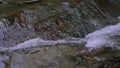 Light water close-up.Creative.A small waterfall that flows down the stones with clear water and slightly bubbling. Royalty Free Stock Photo