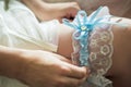 Wedding garter on the bride`s leg Royalty Free Stock Photo