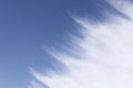 Light white cloud with torn edges floats in blue sky Royalty Free Stock Photo