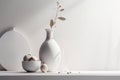Light white vase with dried flower and bowl with apricots casting shadows on the wall