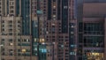 Windows in high-rise building exterior in the late evening with interior lights on timelapse Royalty Free Stock Photo