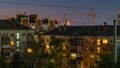 Light in the windows of high-rise buildings at night in summer and half-moon in the sky between houses Royalty Free Stock Photo