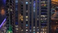 Light in windows of modern towers. Exterior of apartment building at night with glowing windows timelapse. Royalty Free Stock Photo